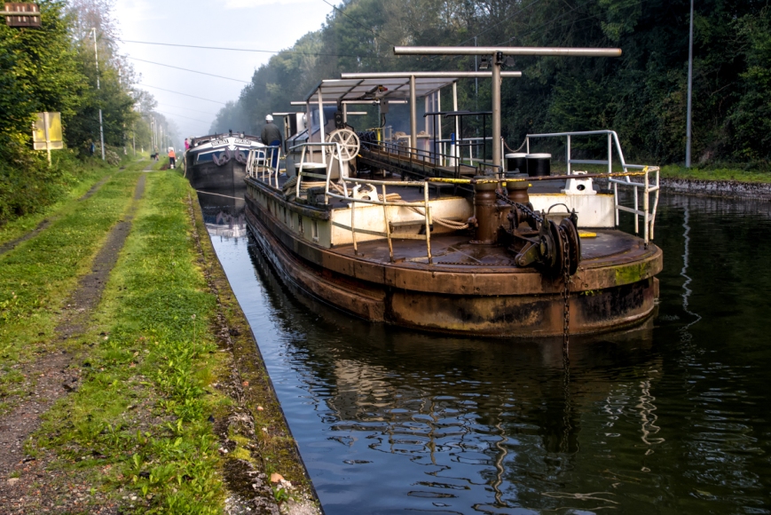 The toueur propels itself by pulling itself along a chain at the bottom of the canal and gets electrical power from a line overhead.